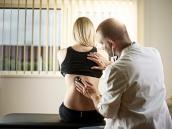 Arzt untersucht eine Patientin mit dem Stethoskop.