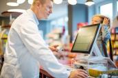 Apotheker bedient Kundin an der Theke