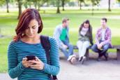 Studentin mit Smarthphone auf dem Campus
