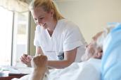 Krankenpflegerin pflegt einen Patienten im Krankenhaus.