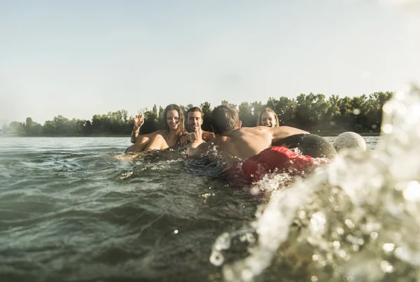 Freunde baden im See: Badeunfällen vorbeugen